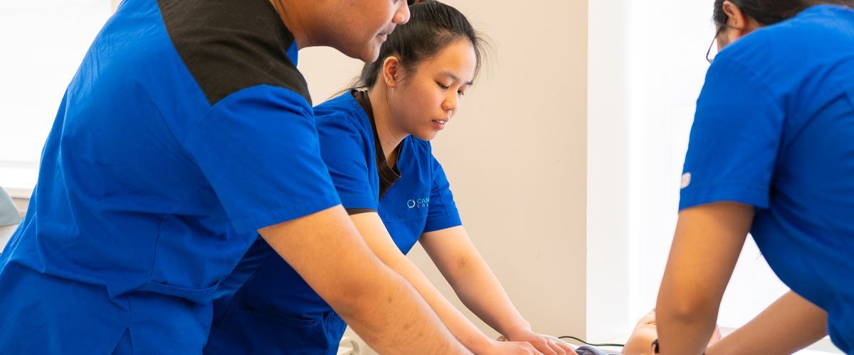 A trainee practising care techniques in a caregiver workshop