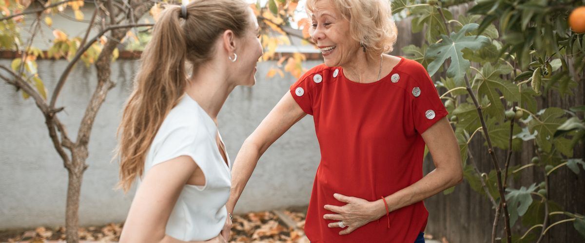 An adult daughter and her elderly mother in conversation