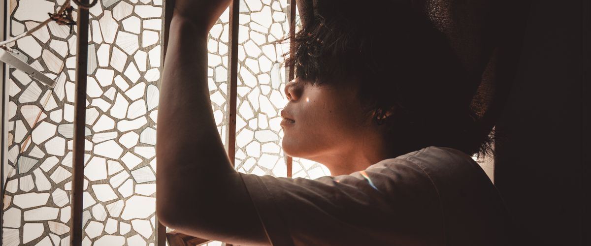 A person deep in thought, weighing a difficult family decision