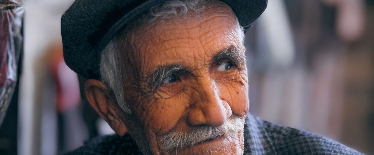 A smiling elderly man, treated with dignity