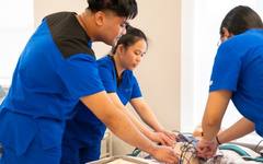 A trainee practising care techniques in a caregiver workshop