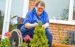 Residents sitting in the garden of a care home