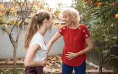 An adult daughter and her elderly mother in conversation