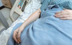 A comforting hand on a patient's arm