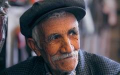 A smiling elderly man, treated with dignity